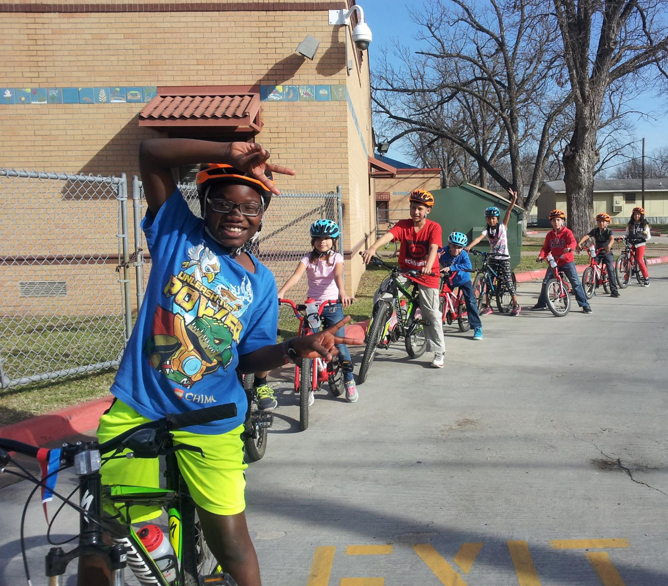 Line of elementary school students on bikes.
